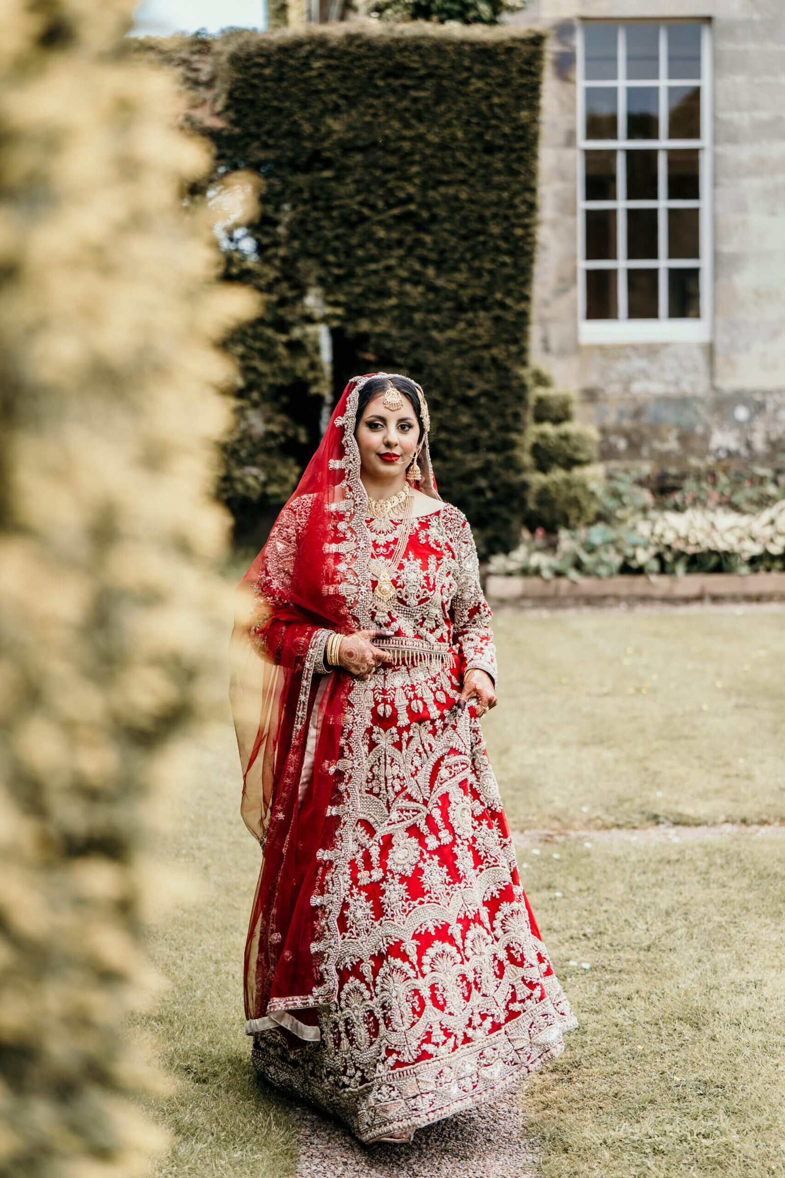 Asian Bride posing outside in the garden in front of Kinmount House Annan