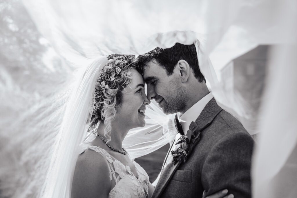 bride and groom veil shot outside newton hall northumberland